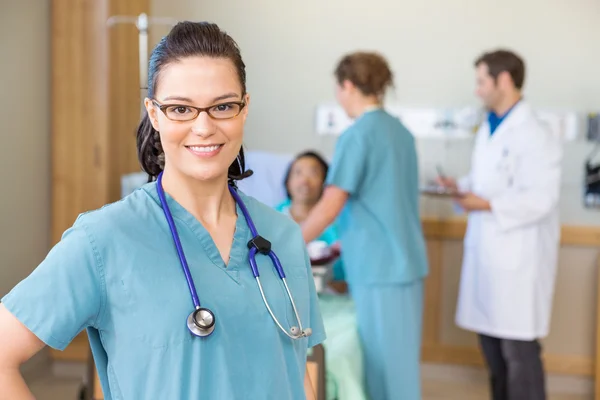 depositphotos_40689531-stock-photo-nurse-smiling-against-patient-and